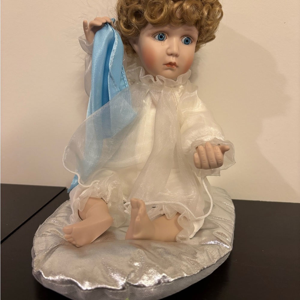Charming Porcelain Doll with Blue Ribbon and Silver Cushion